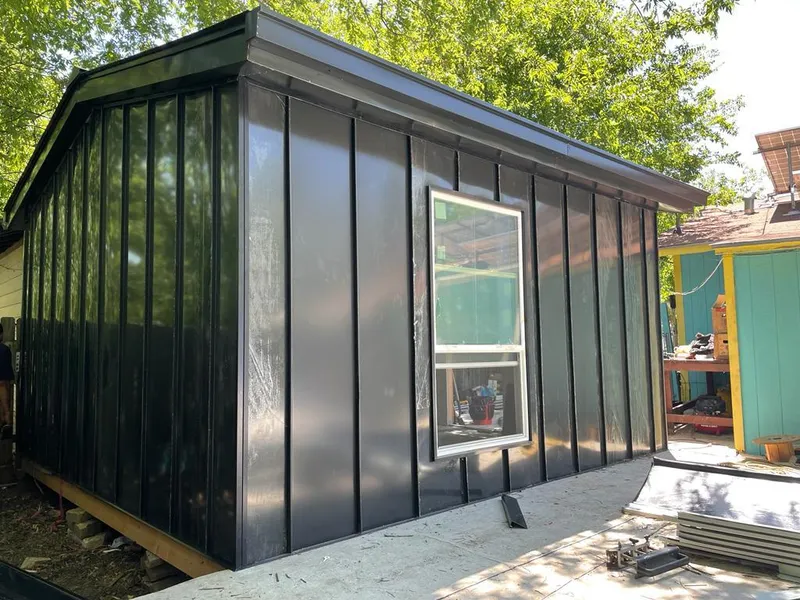 Black standing seam metal wall panels for Roof Inspection in West St. Paul
